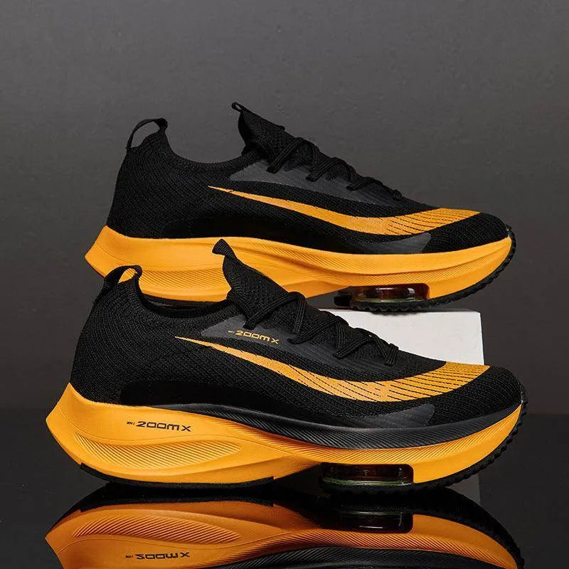 Black and yellow running shoes with 'zoomx' branding on a reflective surface.