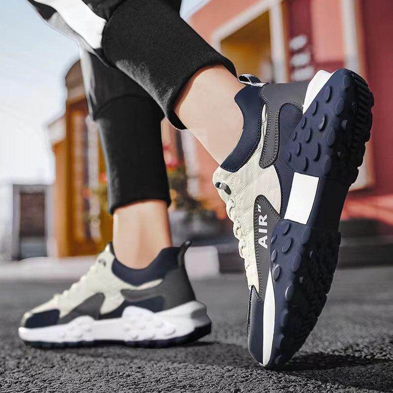 Close-up of black and white sneakers with 'Air' branding on a blurred street background