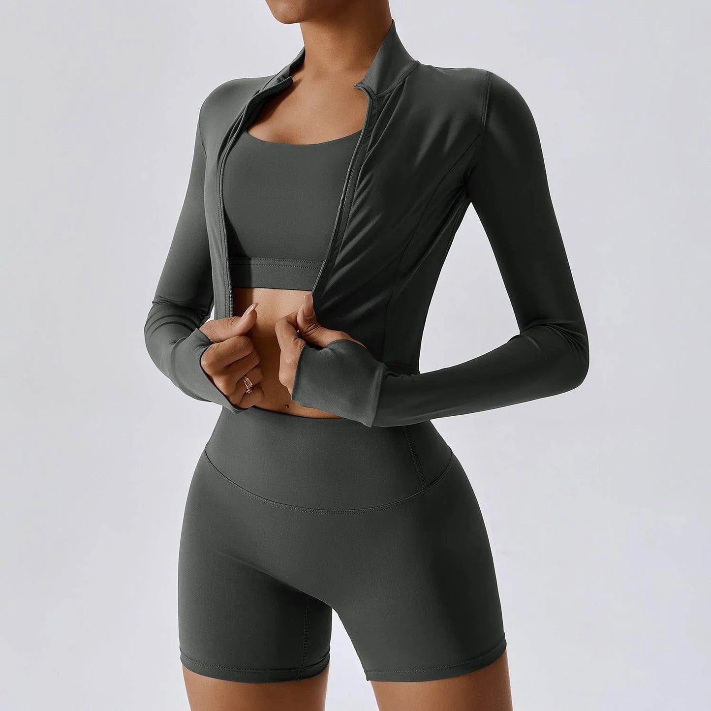 Gray athletic outfit with long-sleeve top and shorts on a plain background
