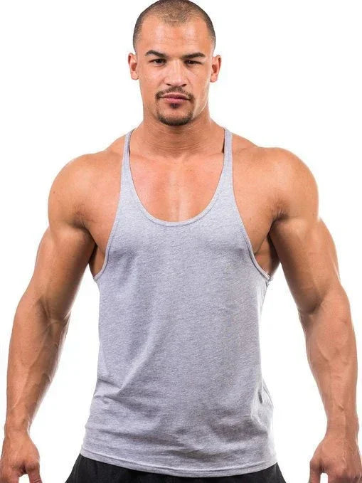 Man wearing a gray tank top on a white background