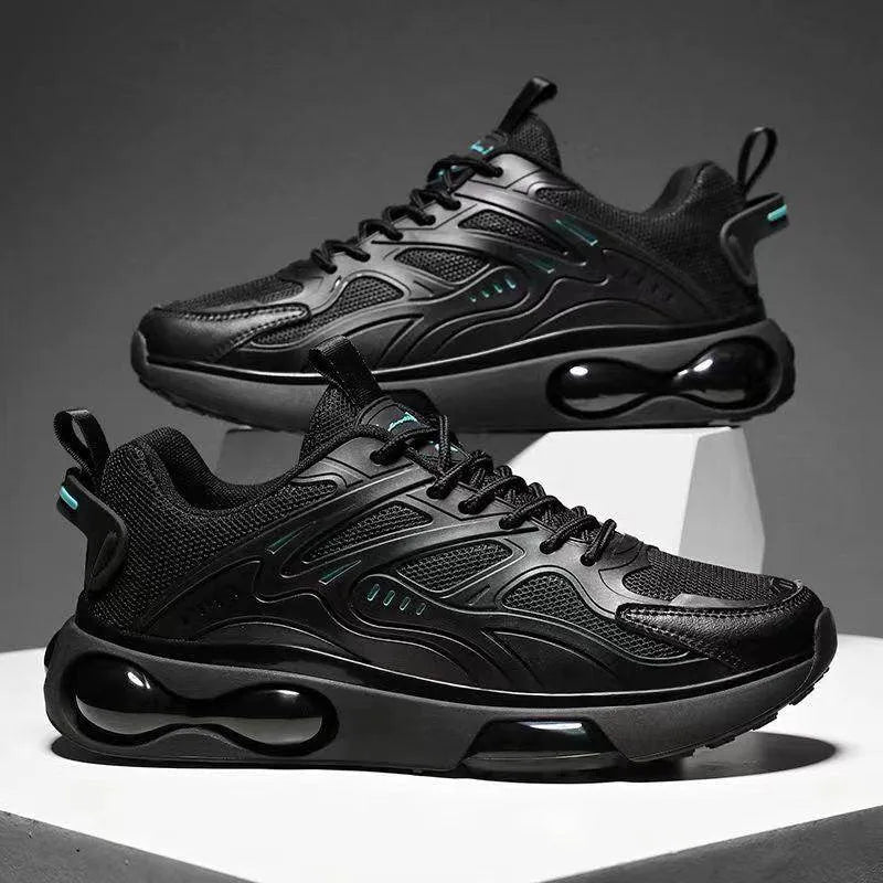 Black athletic shoes with air bubble design on a gray background