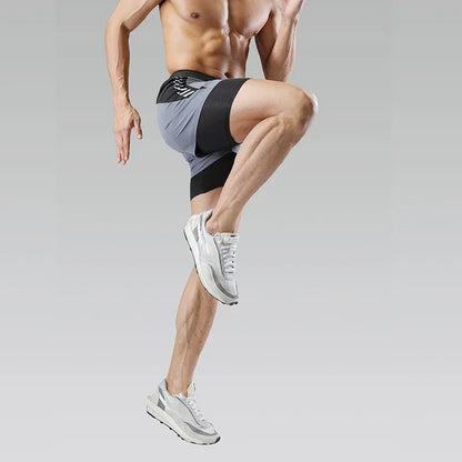 Athlete in black athletic shorts and white sneakers on a gray background