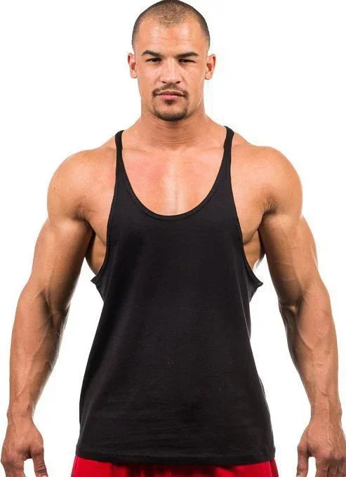 Man wearing a black tank top against a white background