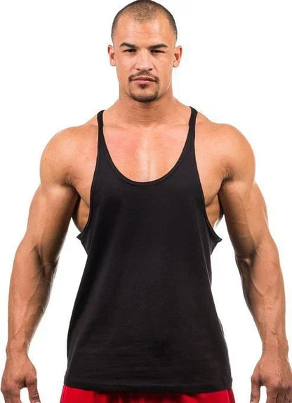 Man wearing a black tank top against a white background