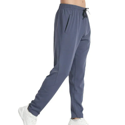Gray jogger pants worn by a person on a white background