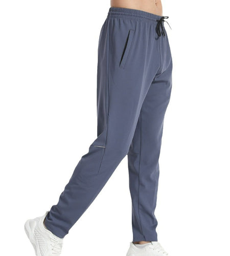 Gray jogger pants worn by a person on a white background