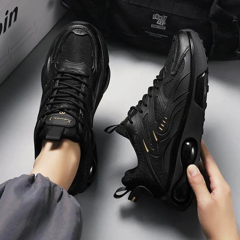 Black sneakers being worn with a gray background