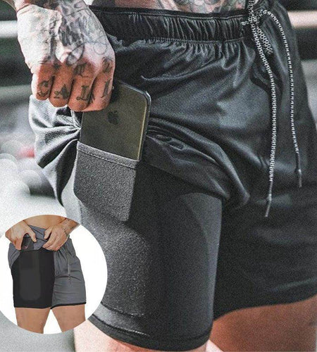 Black athletic shorts with a pocket holding a phone, worn by a person.
